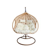 double-hanging-egg-chairs-brown-basket-and-white-cushion